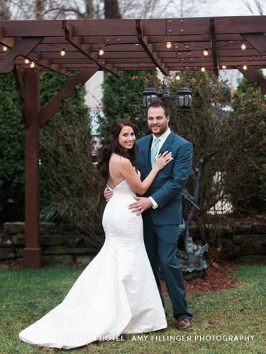 Newlywed couple kissing at outdoor wedding venue in Branson, Missouri.