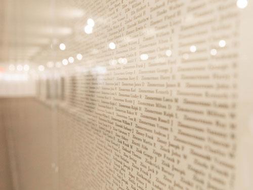 Wall displaying names of the fallen service men and women from World War II at a museum in Branson.