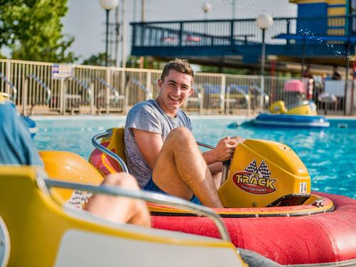 Man spraying water at competitors on Bumper Boat attraction in Branson.