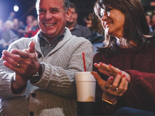 Middle-aged couple sitting in a theatre about to watch a show in Branson.