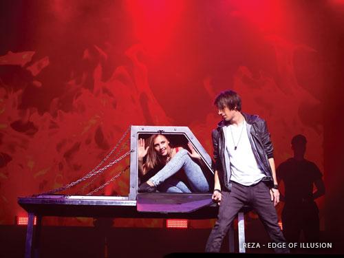 Magician doing a disappearing trick with a woman assistant on a live show stage in Branson.