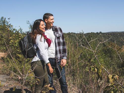 Hispanic couple hiking in Branson's scenic Ozark Mountains.