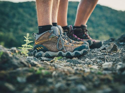 Close look of man and woman's hiking boots during a scenic hike in Branson.