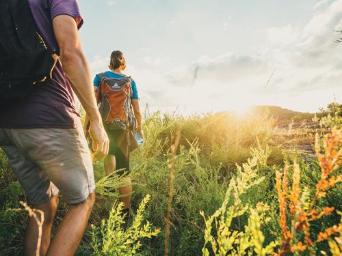 Man and women hiking through scenic Ozark Mountains in Branson.