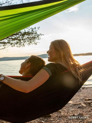 Two girls sitting in a hammock near Table Rock Lake.