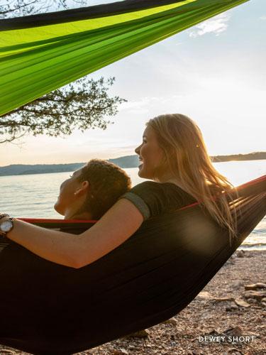 Two girls sitting in a hammock near Table Rock Lake. 