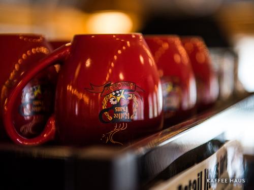 Upside down red coffee mugs in Branson coffee shop.
