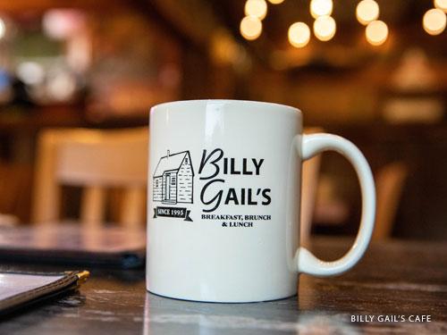 White coffee cup with local Branson cafe's logo on the side.