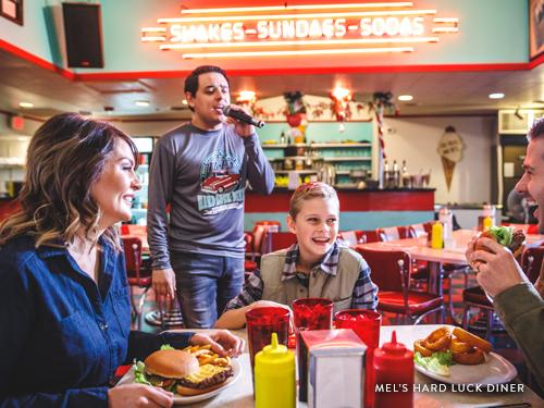Family of three at a diner in Branson where you you are served by singing servers.