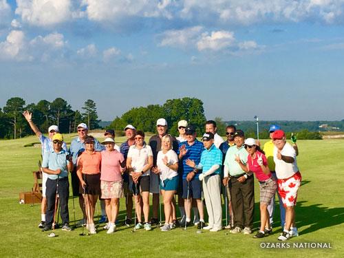 Group of business partners posing for picture at golf course in Branson.