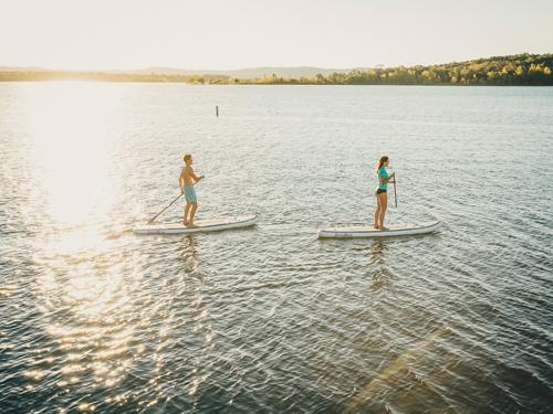 Man and woman paddleboarding in Branson.