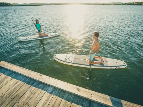 Man and woman paddleboarding in Branson.
