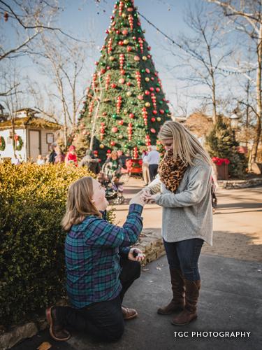 Man on one knee proposing to girlfriend.