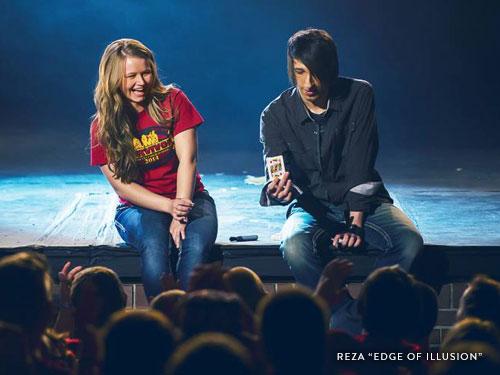 Magician showing off an oreo trick to the crowd.