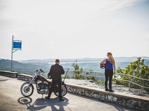 Man and woman stopped at a scenic overlook with their motorcycle in Branson. 