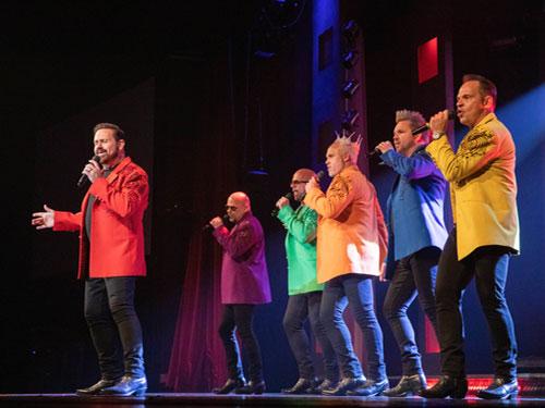 Six brothers performing a cappella on a live music show stage in Branson.