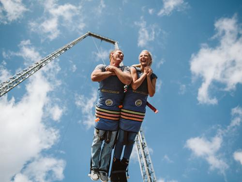 Boy and girl strapped into large swinging attraction in Branson.