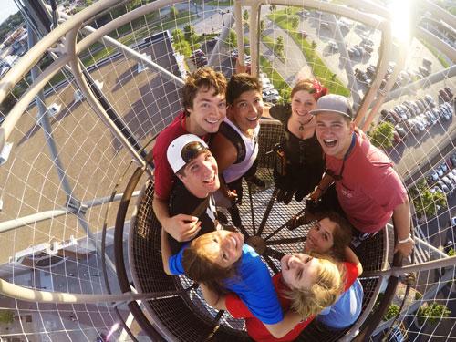 Large group of college-aged students riding a hot air balloon attraction in Branson.