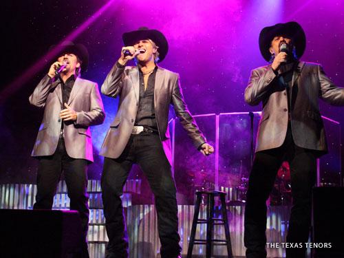 Three male live show performers singing classic country hits on a live show stage in Branson.