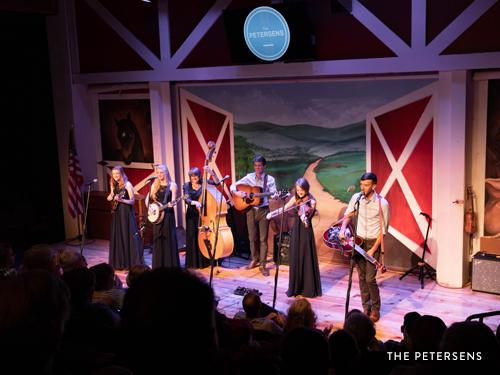 Family bluegrass band performing on Branson live show stage.