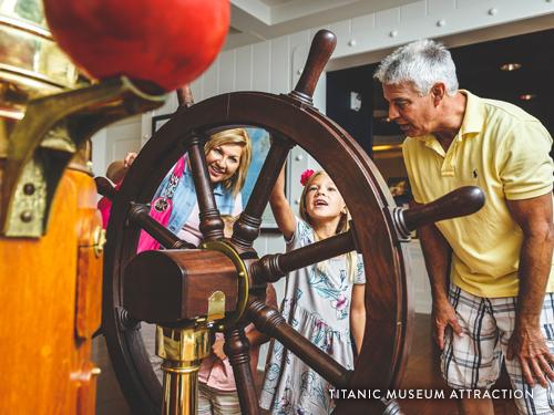 Grandparents exploring the Titanic Museum Attraction in Branson with their young grandchildren.
