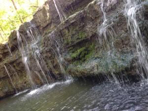 water cascades over the rock face at the end of waterfall trail