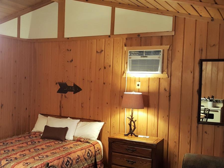 Main room bed and den in two-room lakefront cabin.