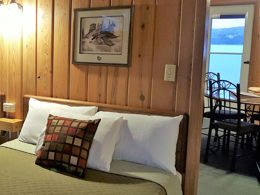 Two-room lakefront cabins with separate sleeping areas, cozy cabin beds.