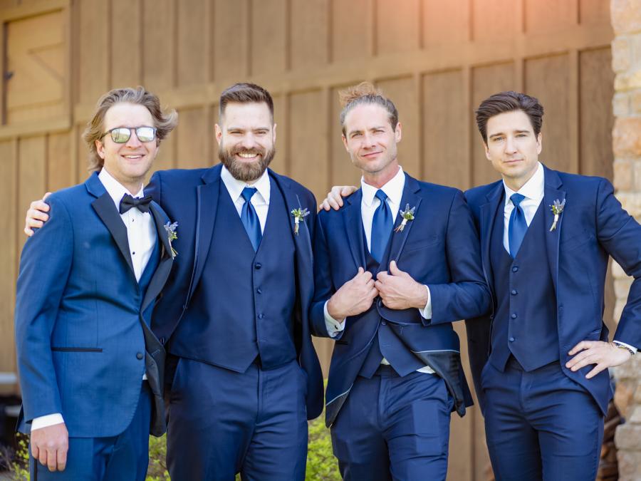 Sharp suits and genuine laughter—these navy-clad groomsmen brought style and fun to this Branson wedding day moment.