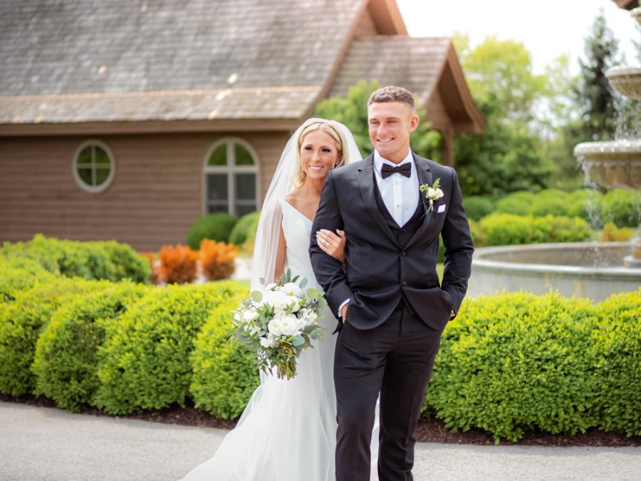 A romantic embrace by the fountain—capturing the love and serenity of a Branson wedding at the breathtaking Integrity Hills venue.