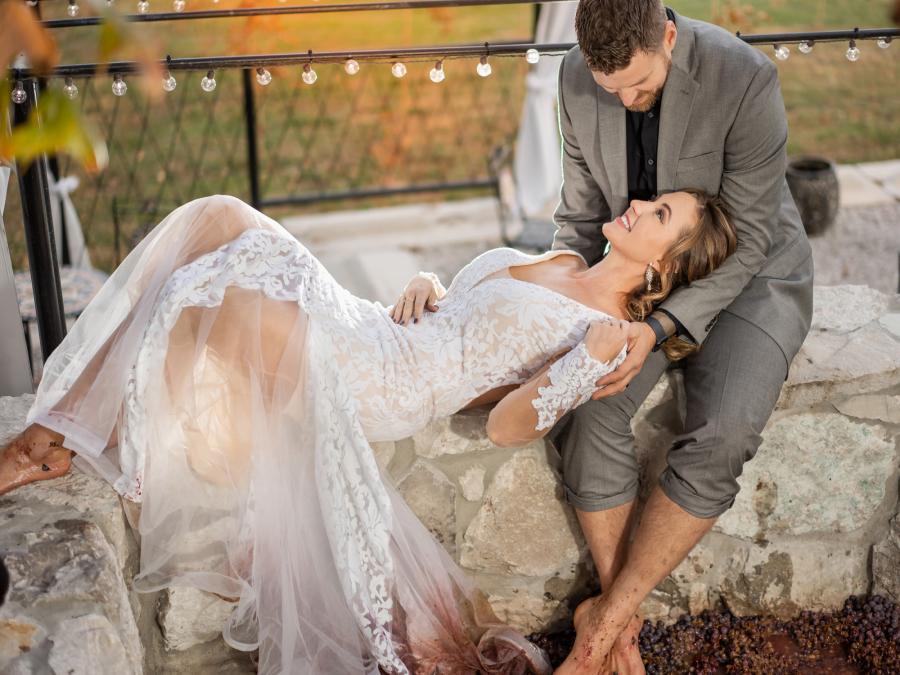 Bride and Groom relax at winery during wedding grape stomp