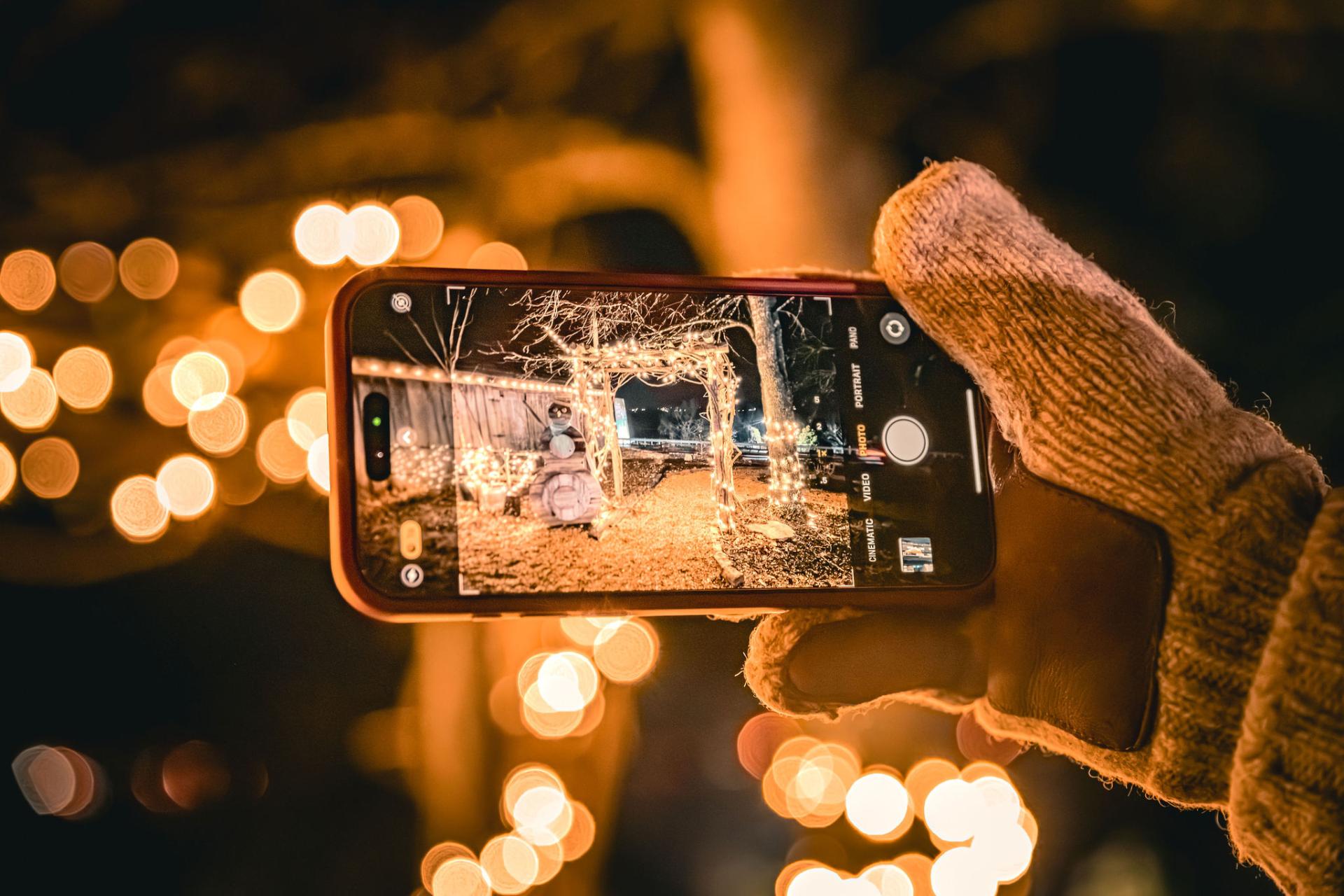 Photo of a phone taking pictures of lights at night