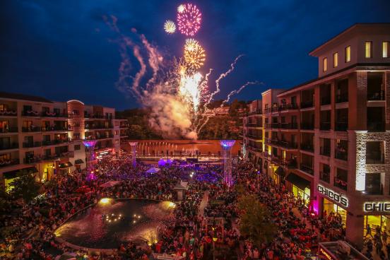 Fireworks at night with a large crowd at Branson Landing.