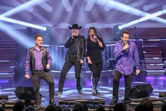 clay cooper and other performers on stage with purple lights in branson mo