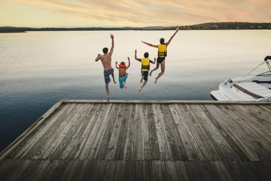 family jumping into the lake
