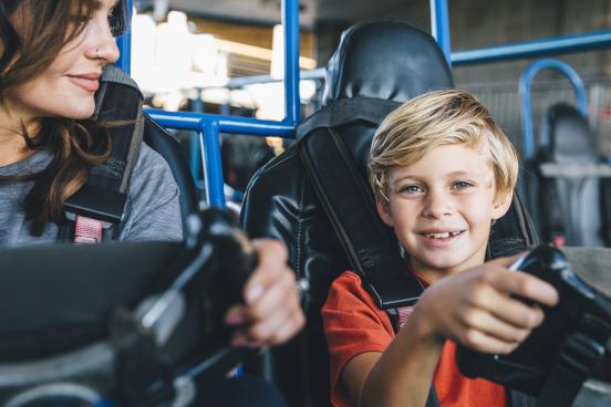 A boy and his mom ride go karts at the Track Family Fun Park