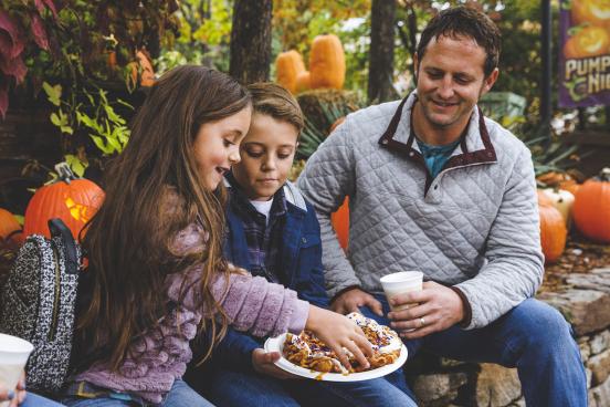 A family sits and enjoys some fall-themed dessert at SDC