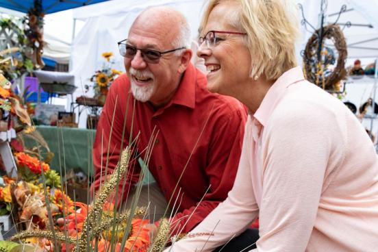Husband and wife shopping at an outdoor fall craft fair in Branson.