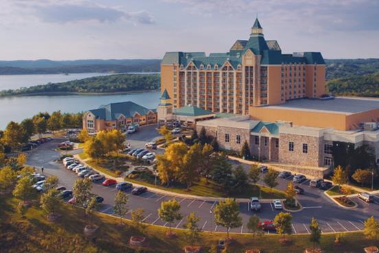 Large, multi-story resort hotel sitting on the shore of a large, scenic lake in Branson. 