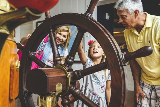 Grandparents exploring the Titanic Museum Attraction in Branson with their young grand daughter.