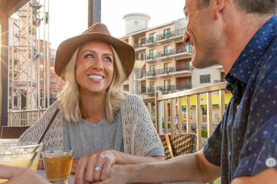 Middle-aged couple on a date at Cantina Laredo on the Branson Landing during sunset.