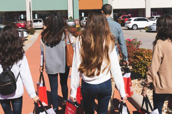 Family of five shopping at an outlet mall.
