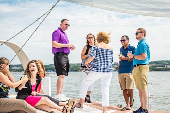 Group of business partners conversing on a catamaran in Branson.