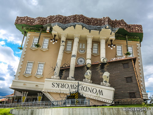 Attraction that looks like a huge upside-down yellow mansion or house in Branson.